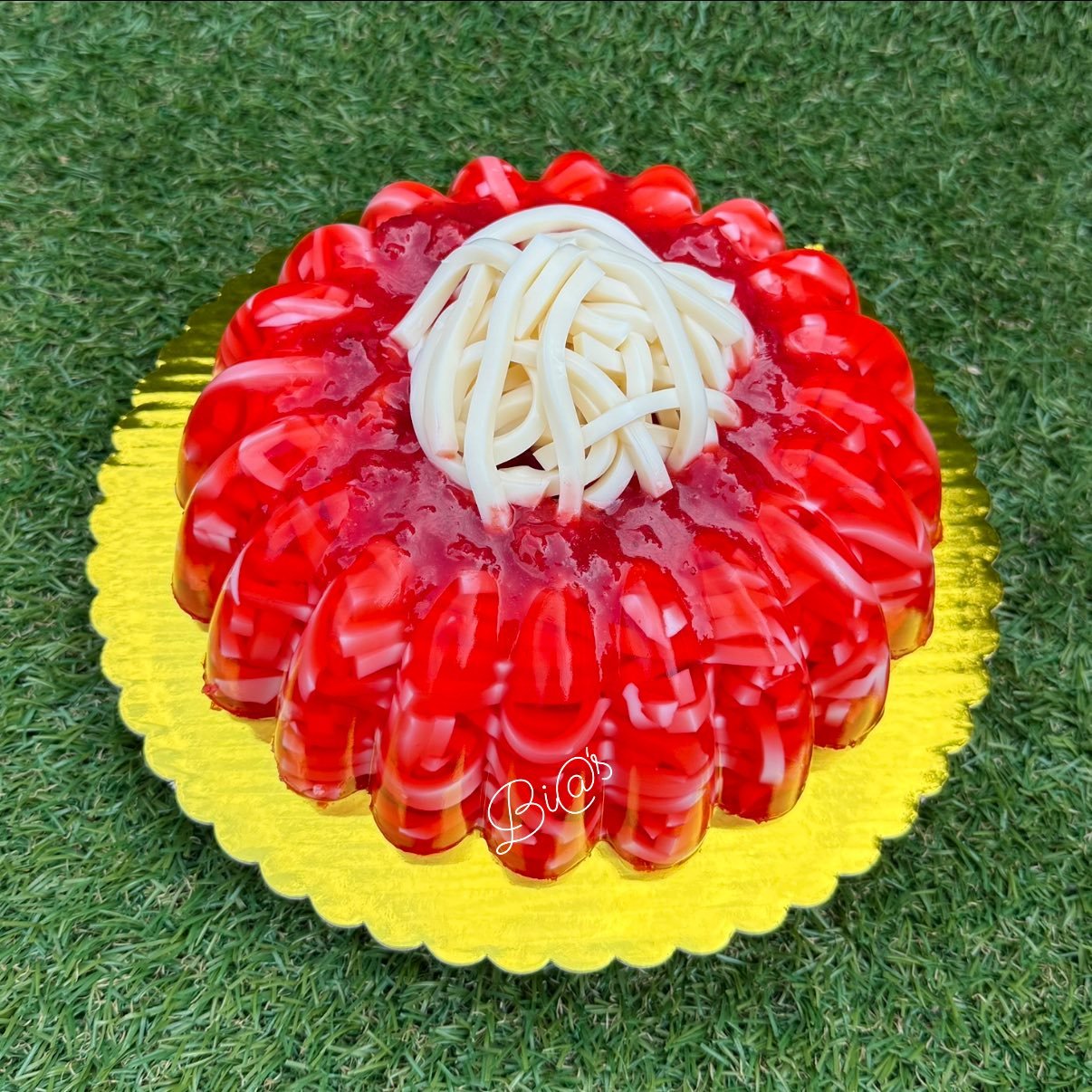 Red gelatin tres leches cake topped with cream, made to order in Lincoln, Nebraska