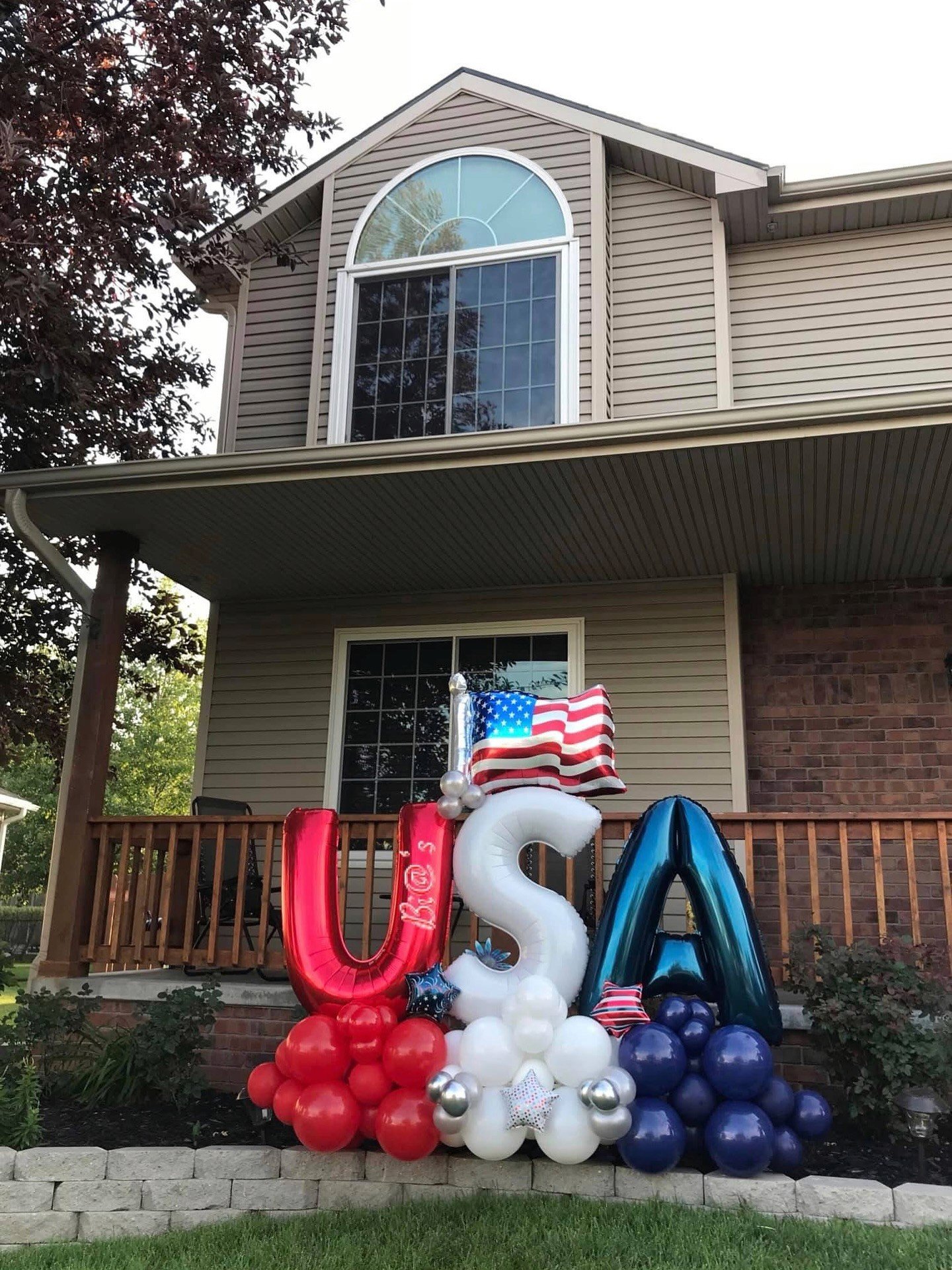 Red, white, and blue USA balloon display built for a Lincoln front porch