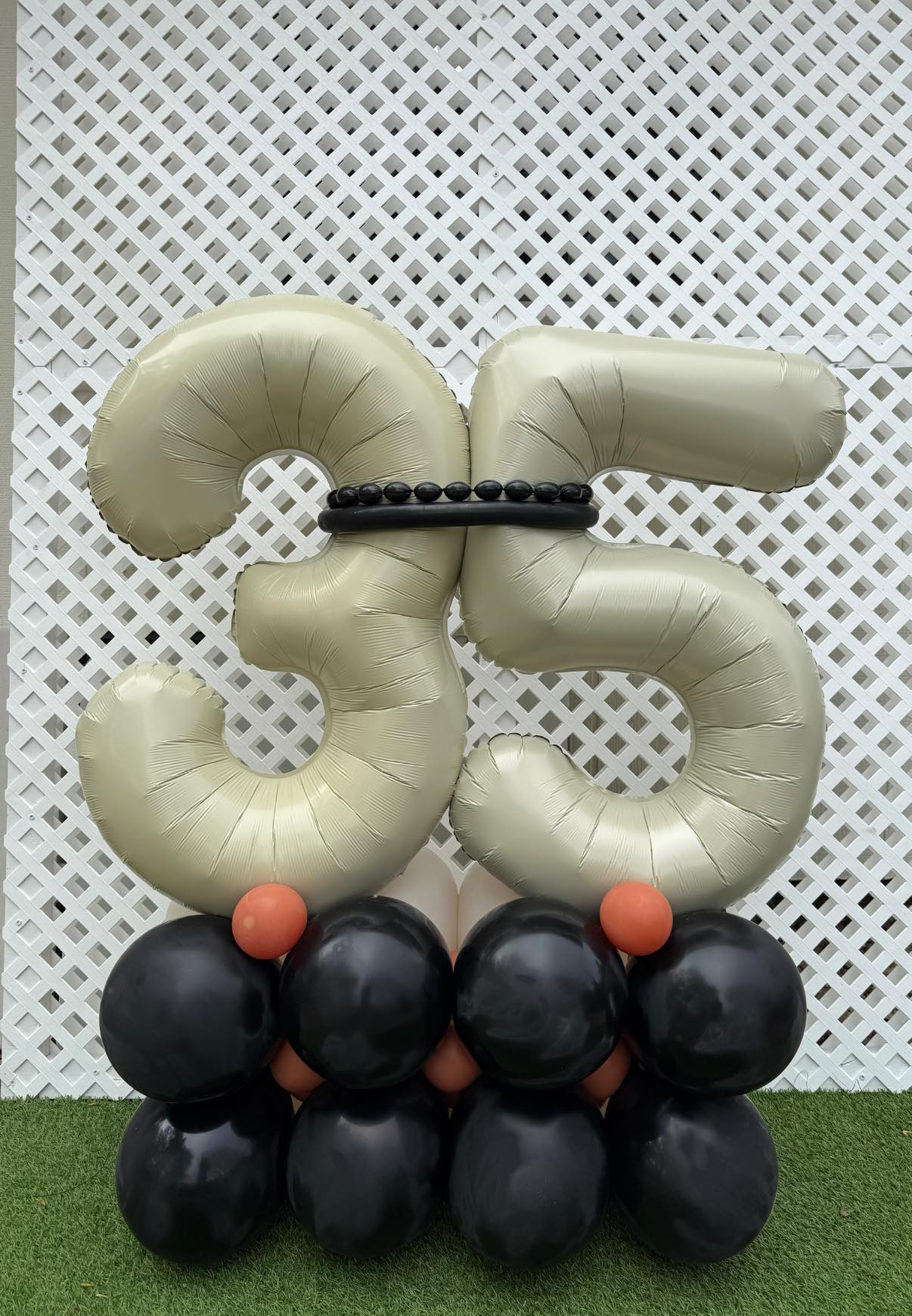 Sage and black 35 number balloon display for a Lincoln birthday
