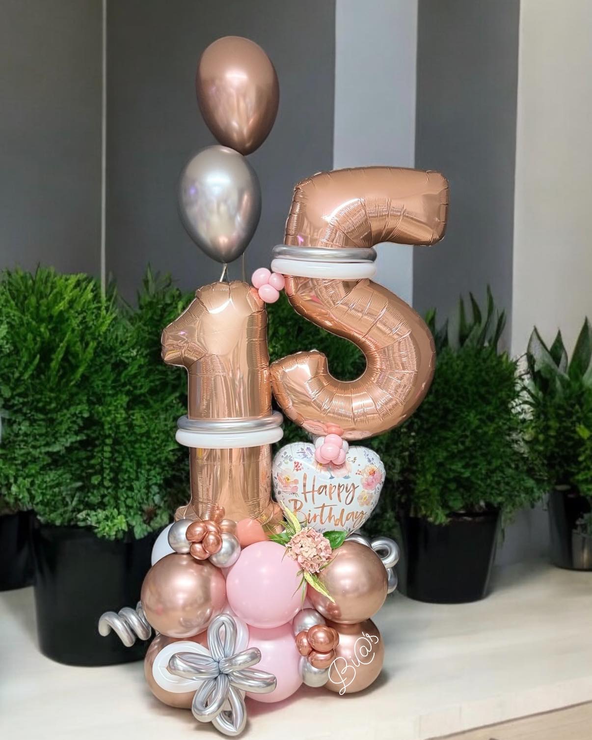 Rose gold 15 balloon display built for a quinceañera in Lincoln, Nebraska