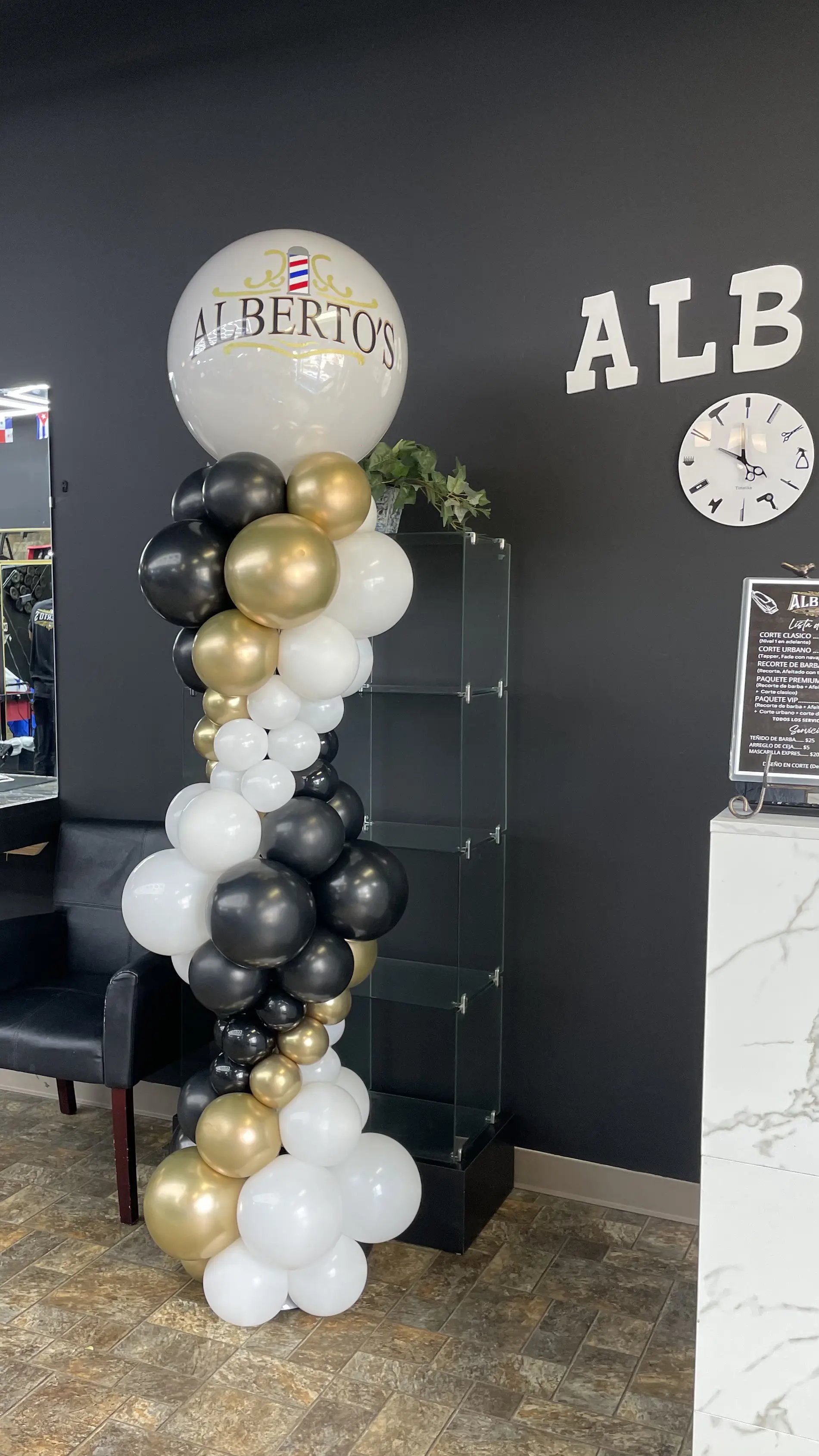 Black and gold balloon column installed at a Lincoln business