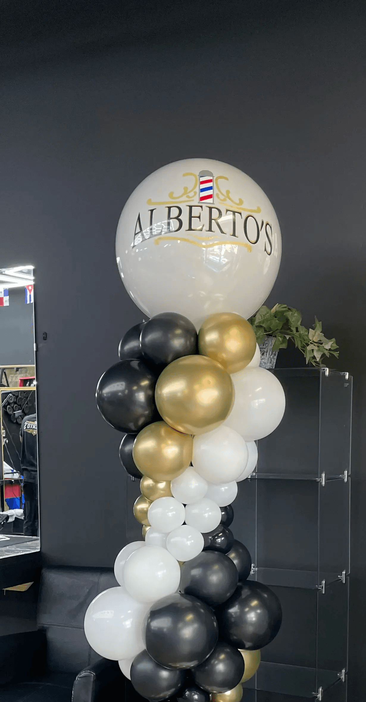 Elegant black, white, and gold balloon column